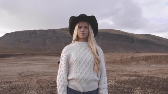 Young Woman In Cowboy Hat In Icelandic Landscape