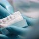 Hands of Dentist Place Dental Implant in Plaster Model of Teeth - VideoHive Item for Sale