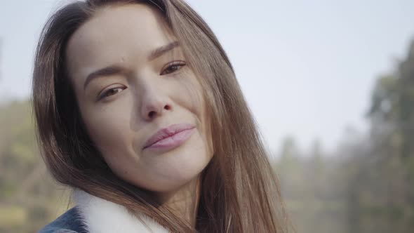 Close-up Portrait of Pretty Young Smiling Woman Looking in the Camera. Beautiful Landscape, River on