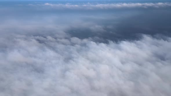 Aerial View From High Altitude of Earth Covered with Puffy Rainy Clouds Forming Before Rainstorm