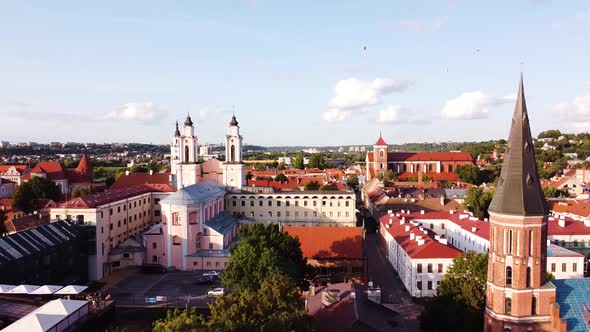 Kaunas city old town aerial drone shot while the drone is flying backwards revealings beautiful chur