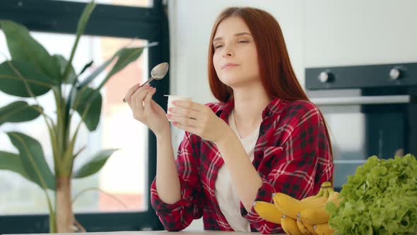 Domestic Young Woman Housewife Redhead Female Eating Yogurt with Fresh Fruits Tasting Natural Milk