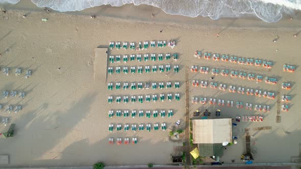 Quadcopter Flies Up Over the Sun Loungers on the Seashore