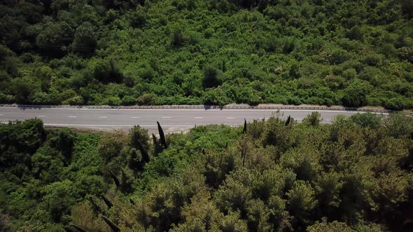 Aerial View From Above of Road with a Car on the Mountain with Green Forest in Russia