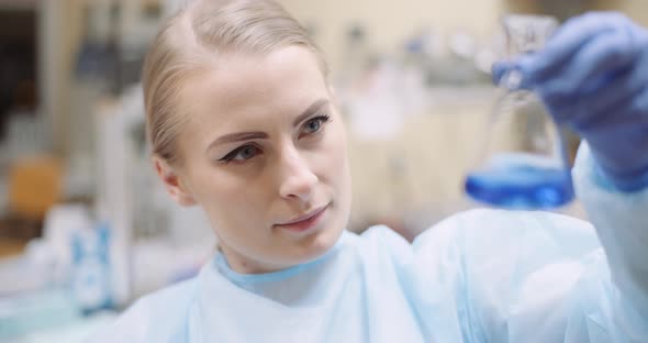 Scientist Mixing Liquid at Laboratory