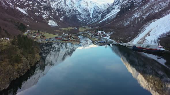 High altitude aerial approaching amazing old Viking village Gudvangen in Norway - Aerial looking dow