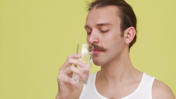 Closeup Darkhaired Man in Shirt Drinking Water From Glass with Pleisure Smiling Afterwards Over