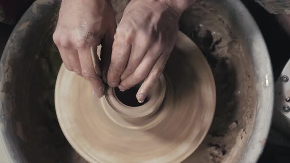 The Hands of a Potter Creating an Earthen Jar on the Circle Closeup Hands on Circle with Clay