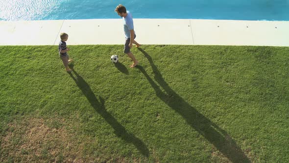 WS OF A FATHER AND SON PLAYING FOOTBALL