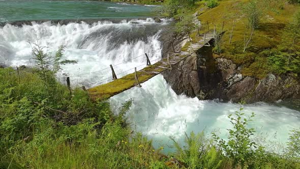 Suspension Bridge Over the Mountain River Norway