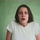 Startled Young Woman Opens Mouth Near Studio Green Wall - VideoHive Item for Sale