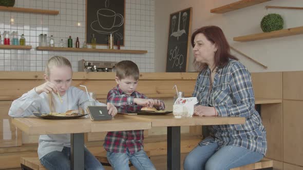 Babysitter Forbidding Kids Gaming Phones in Cafe