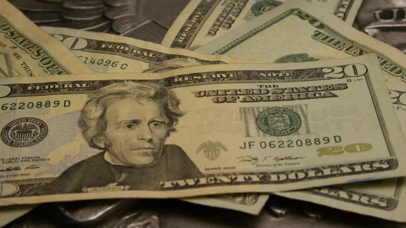 Rotating footage shot of American paper currency on an American eagle shield background