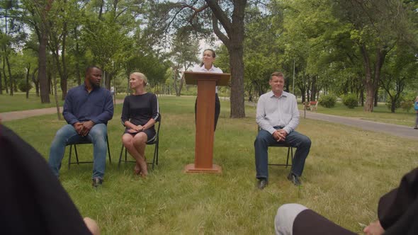 Lovely Female Professor Giving Parting Words to Diverse Graduates at Graduation Ceremony