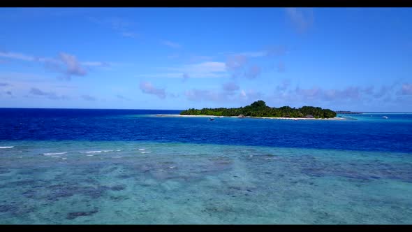 Aerial drone shot landscape of perfect lagoon beach trip by blue green ocean with clean sandy backgr