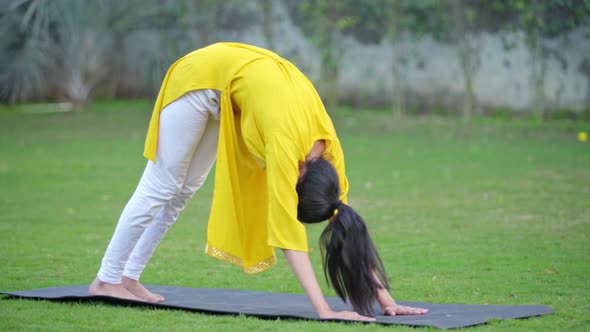 Yoga is being done by an Indian woman