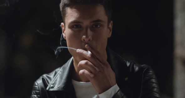 Outdoor Portrait of Serious Man Smoking at Night Park, Slow Motion