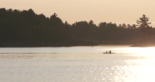 Kayakers out for an evening paddle on the lake during sunset