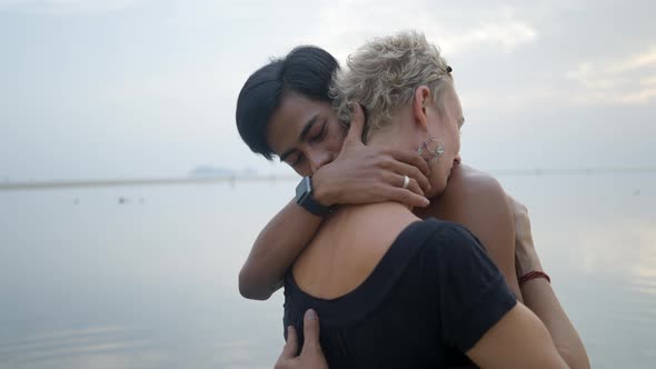 Bust Shot of Thai Young Man and Mature Caucasian Woman Kissing at Seaside Sunset Beach  Slow Motion