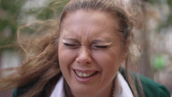 Headshot Overwhelmed Overburdened Plussize Woman Crying Outdoors on Windy Day on City Street