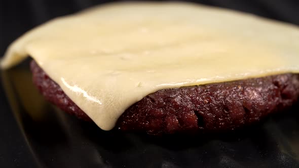 Time Lapse Cooking Cheeseburger  Cheese Melting on Burger Meat Cutlet on Grill Plate