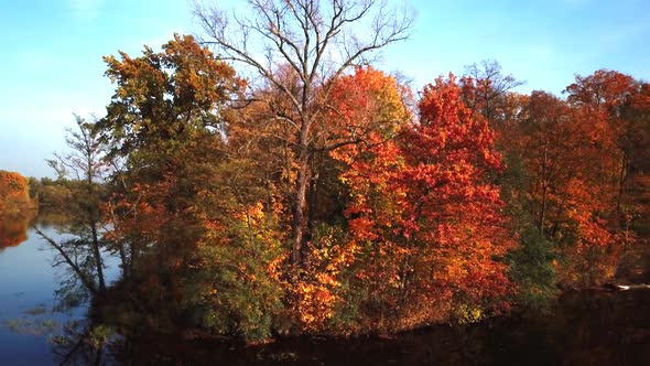 Autumn Landscape. Park in Autumn. The bright colors of autumn in the park by the lake. Aerial shot.