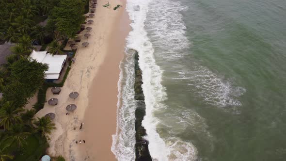 Aerial forward view of a beautiful beach, with coastal erosion made by a typhoon. Vietnam, Real time