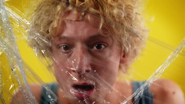 Front View Headshot of Young Caucasian LGBT Man Looking at Camera Opening Mouth Posing at Yellow