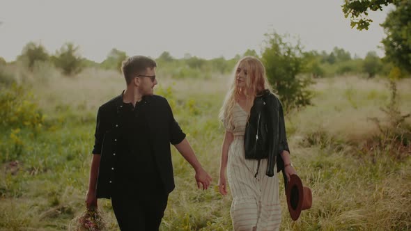 Carefree Young Couple Walking and Smiling on Holiday on Countryside  Freedom and Happiness Concept