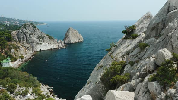 Aerial Fly Behind Rock Krylo Lebedya  Swan Wing with Diva Rock and Black Sea in Background