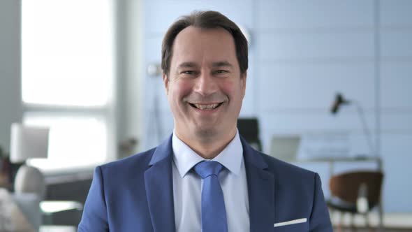 Portrait of Smiling Businessman in Office