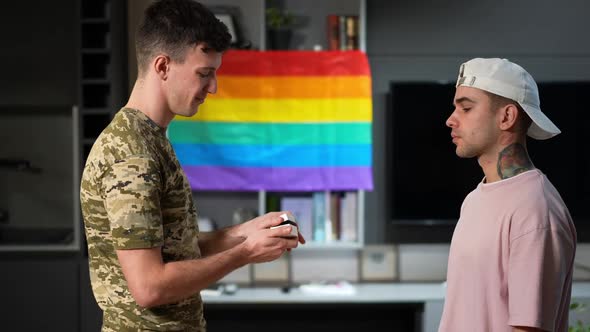 Side View Young Gay Man Refusing Proposal of Military Partner Indoors at Home