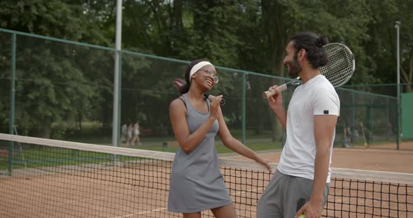 Couple of Tennis Players Talking at the Court After a Match