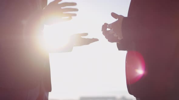 Hands of Businessmen Discussing Work on Sunny Day