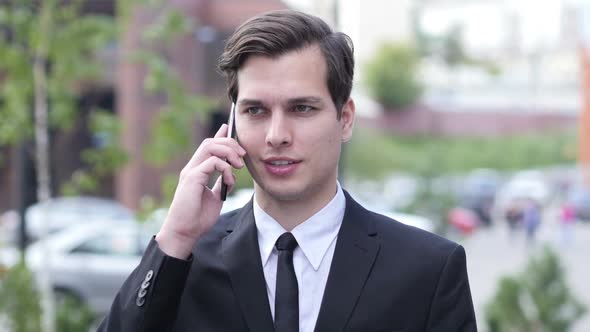 Outdoor Businessman Talking on Phone Call, Discussing Project