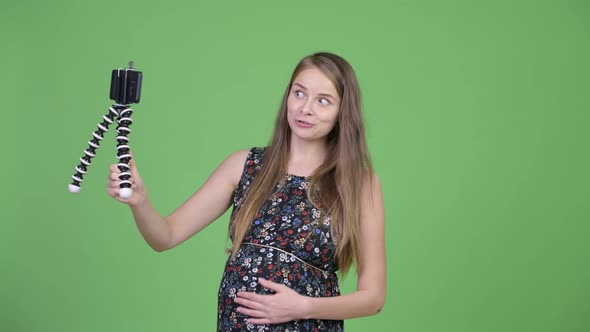 Young Happy Pregnant Woman Vlogging with Phone