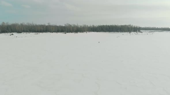 White Boundless Frozen River Surface at Forest Aerial View