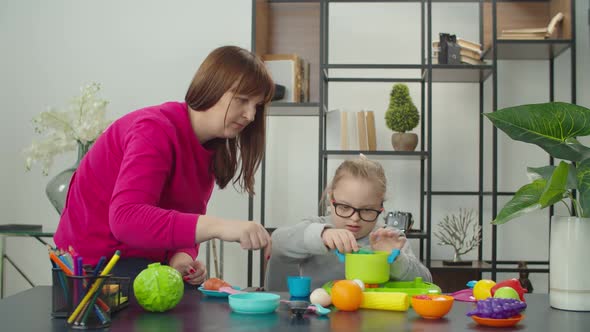 Mom with Disabled Daughter Playing Kitchen Toy Set
