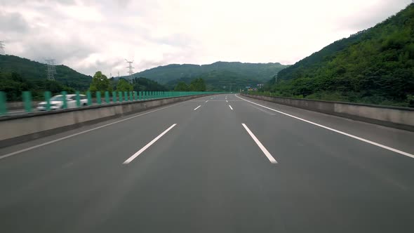 Fast Moving Over Modern Highway Three Traffic Lane Road Between Hills