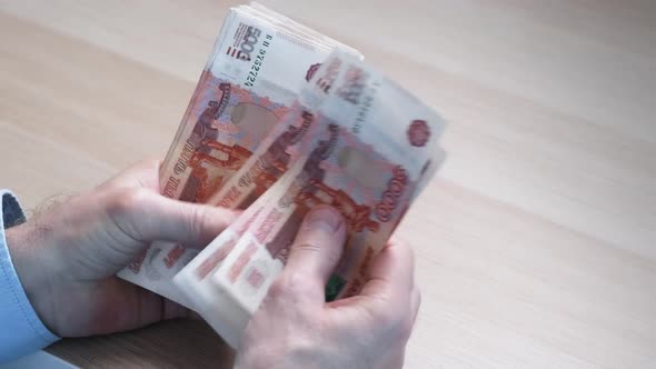 Closeup of Hands Counting Fivethousandth Banknotes of the Russian Ruble