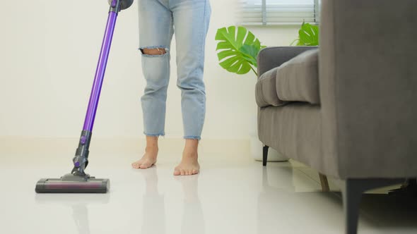 Asian cleaning service woman worker cleaning in living room at home.