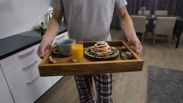 Midsection of Man with Breakfast Tray Walking