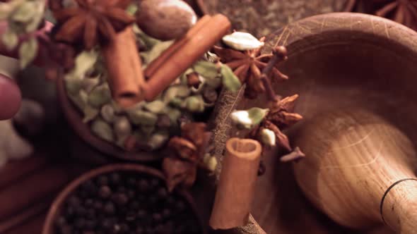 Wood Mortar and Spice Species Falling in Slow Motion