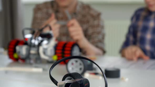 Children Looking at the Instructions of the Toy Vehicle Building