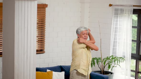 Portrait Asian senior man exercise in the living room at home.