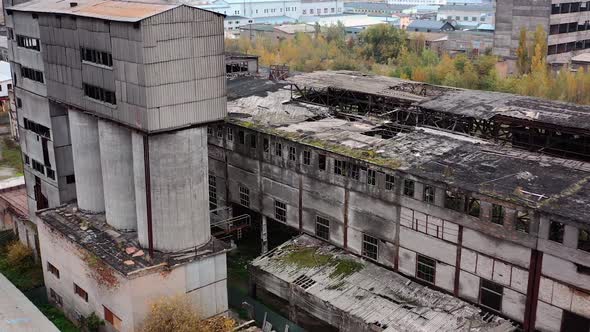 Old abandoned factory. Exterior of ruined buildings with many holes 