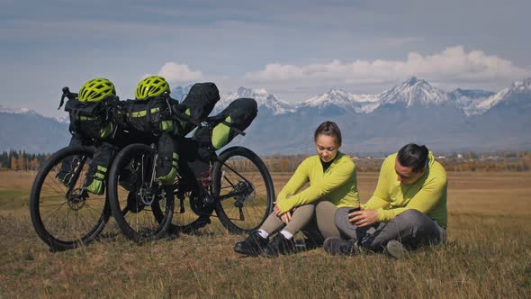 The Man and Woman Travel on Mixed Terrain Cycle Touring with Bikepacking