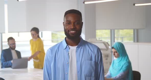 Portrait of Cheerful Smiling Afro Businessman Offering Handshake at Bright Office