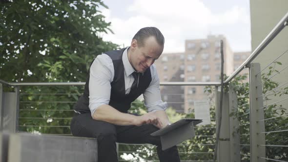 Businessman using digital tablet outdoors