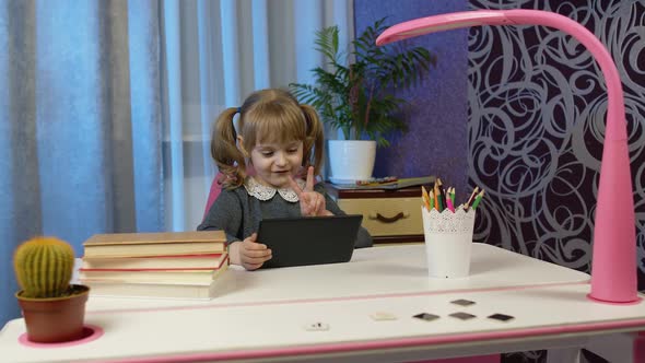 Girl Doing Online Homework with Teacher Using Digital Tablet Computer at Home Distance Education